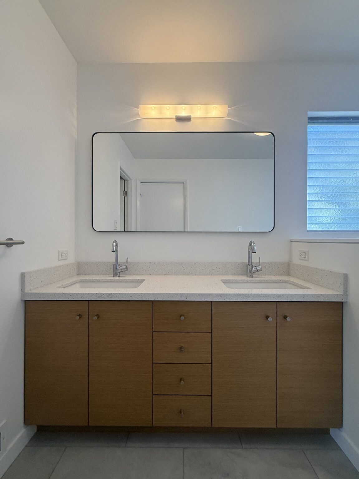 Double vanity in rift-sawn white oak with book-matched grain, in a remodeled Montclair bathroom in Oakland