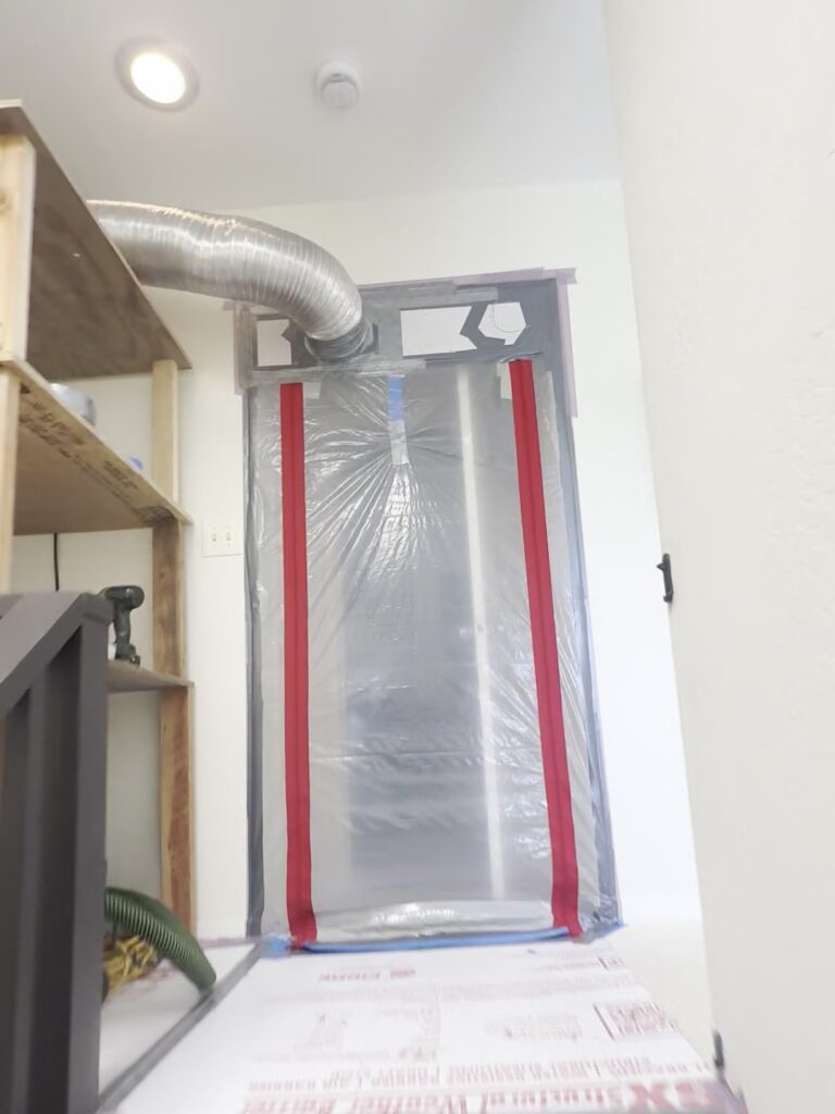 Stair treads covered in taped-down thermoply, leading up to the zip wall around the bathroom