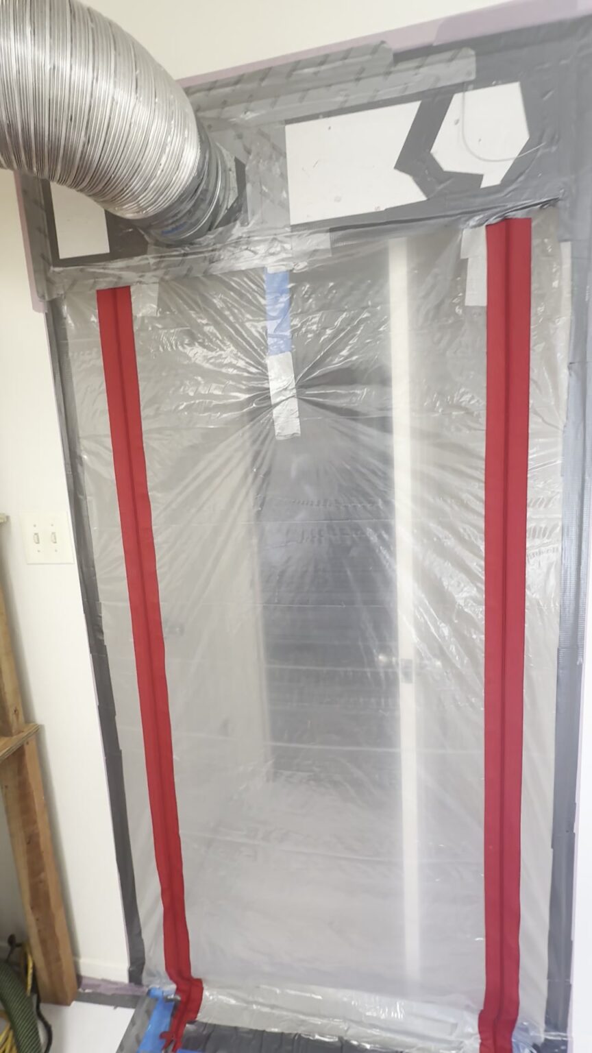 Plastic zip wall sealing off a third-floor bathroom, with a duct bringing in clean air, the dust plan for living through a bathroom remodel in Montclair, Oakland